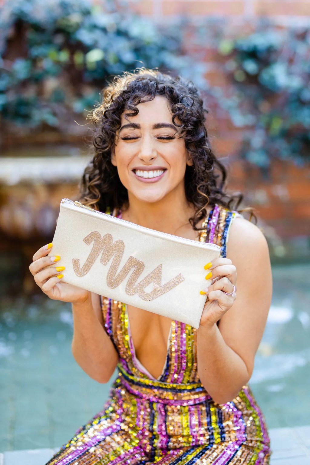 bride holding a monogrammed mrs bag during her Golden Girls theme bachelorette party